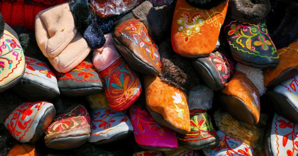 a-vibrant-assortment-of-handmade-embroidered-cozy-slippers-showcasing-traditional-designs-and-bright-colors